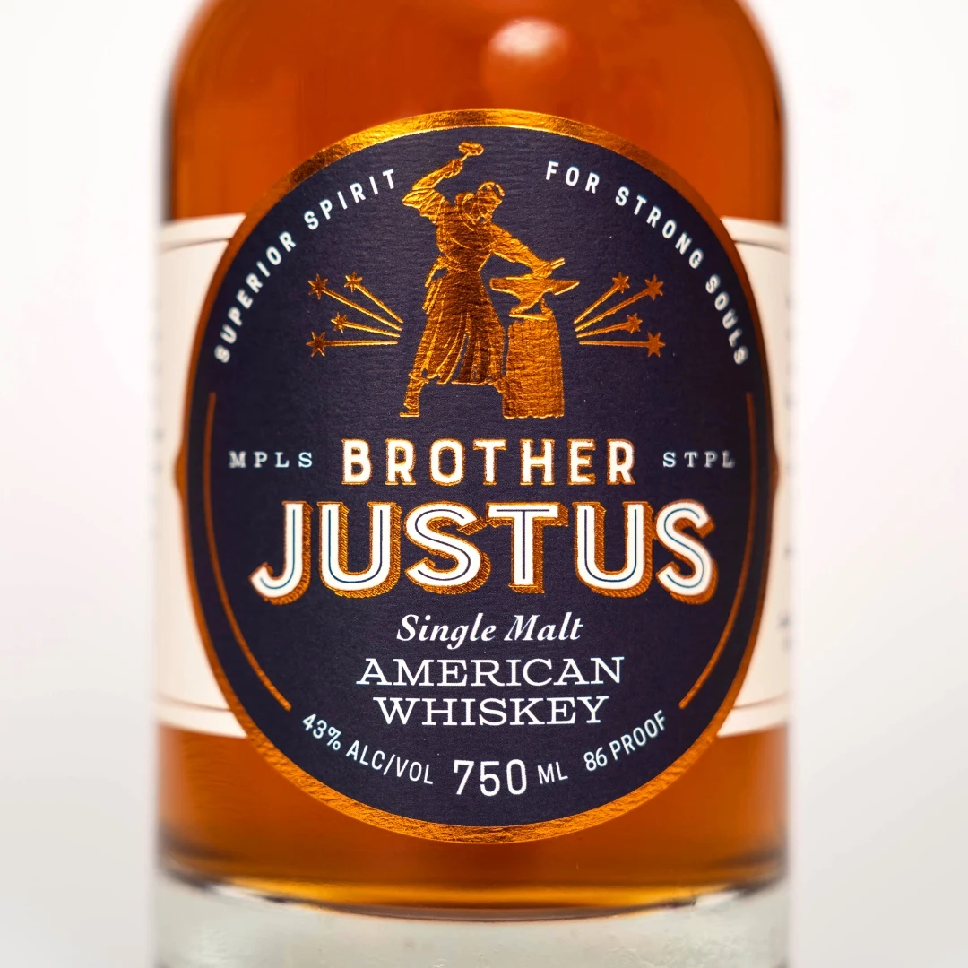 Brother Justus Single Malt American Whiskey bottle full frontal label with monk-blacksmith emblem