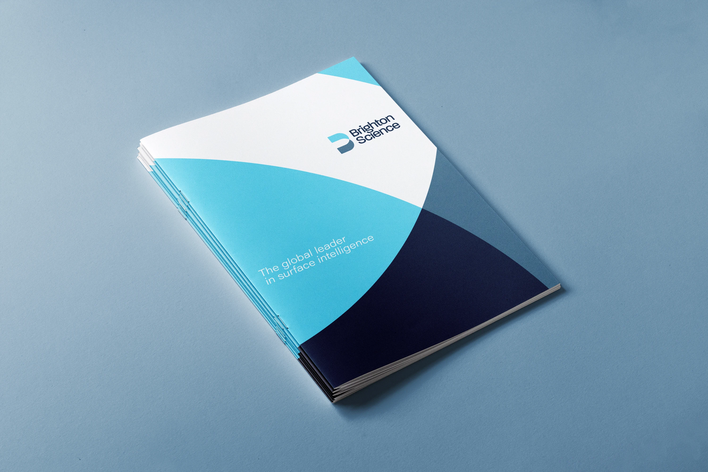 Brighton Science branded folder with geometric curve pattern and surface intelligence tagline