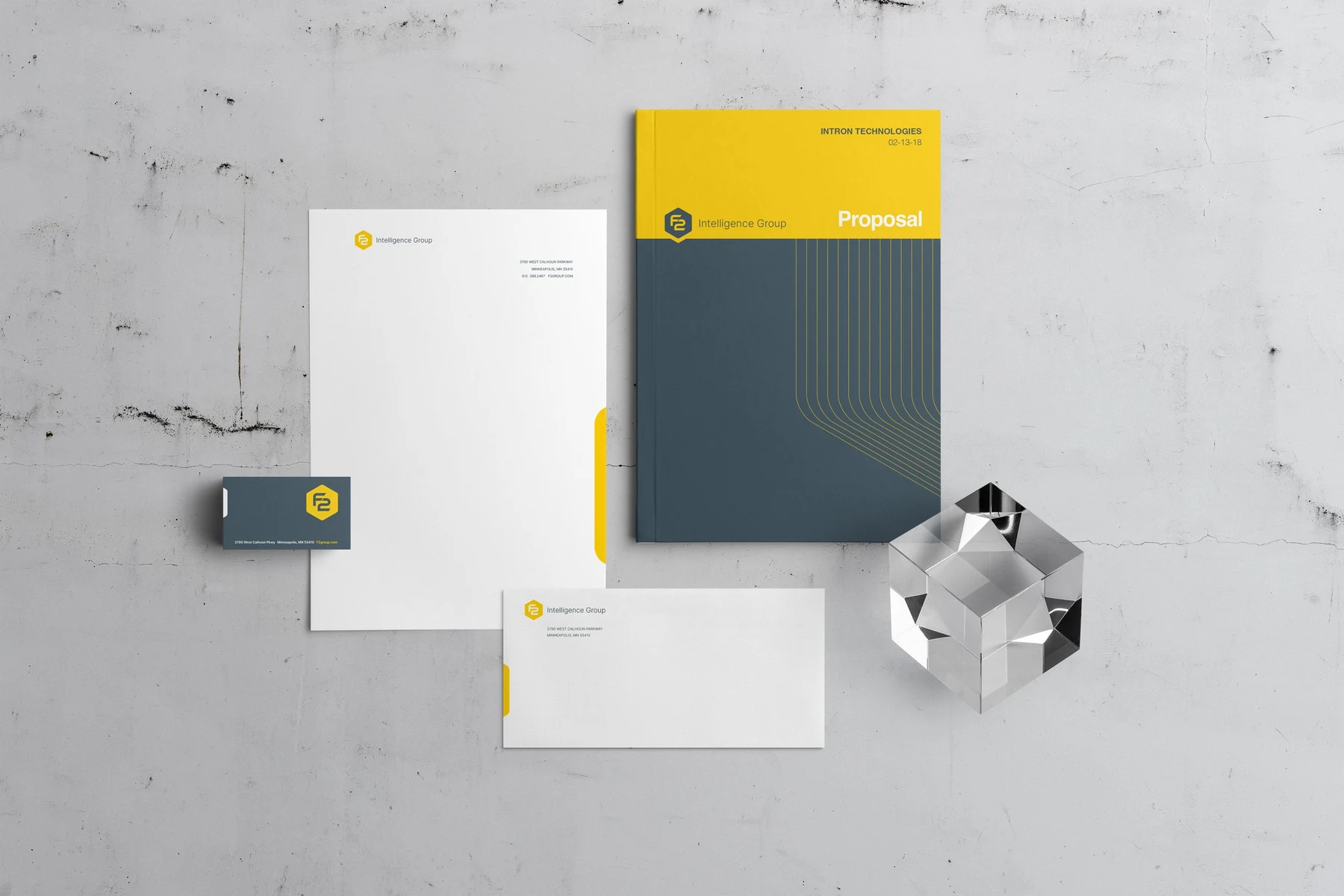 F2 branded stationery and collateral with geometric glass sculpture