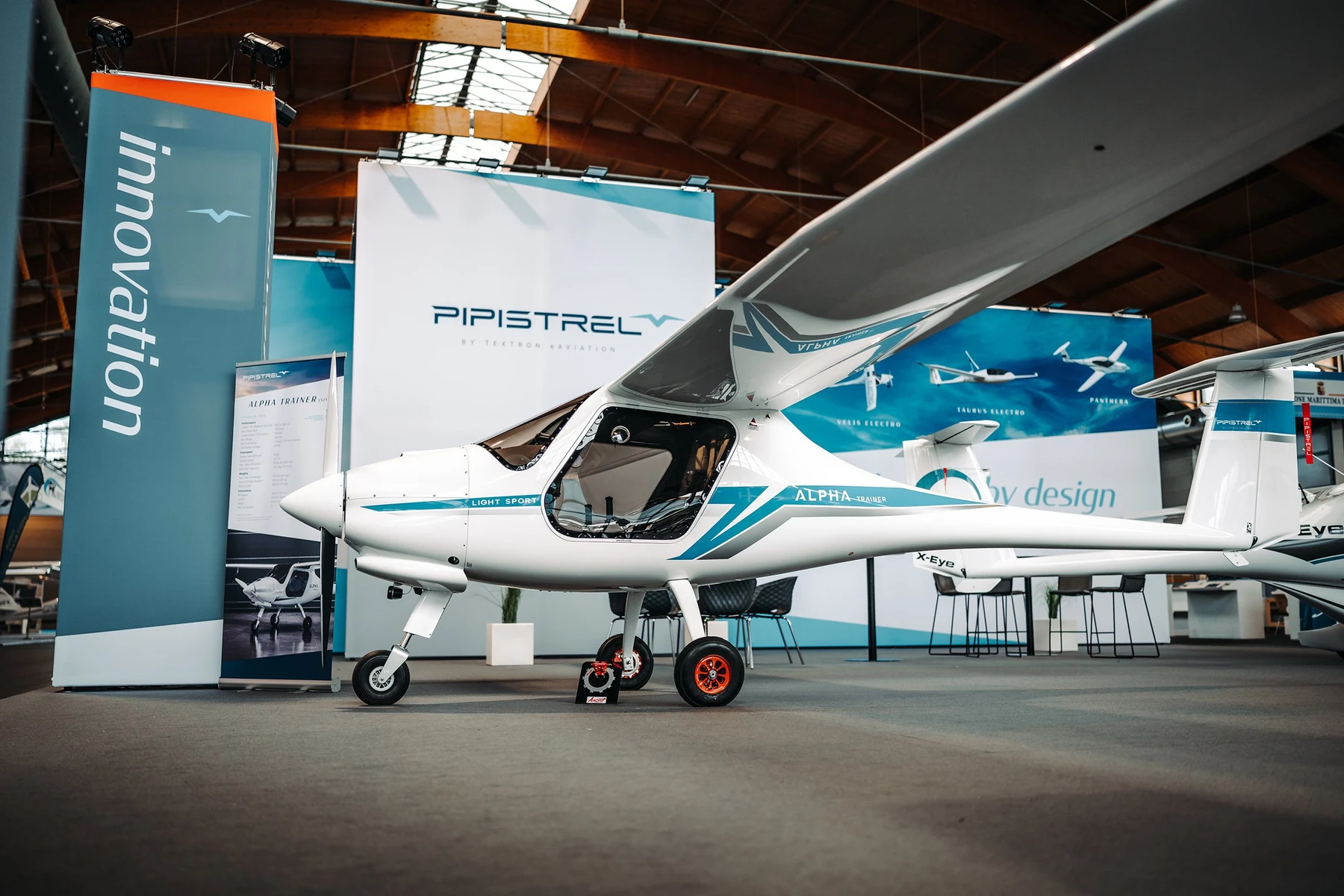 Pipistrel Alpha Trainer aircraft on display at an aviation expo with full Pipistrel by Textron Aviation branding